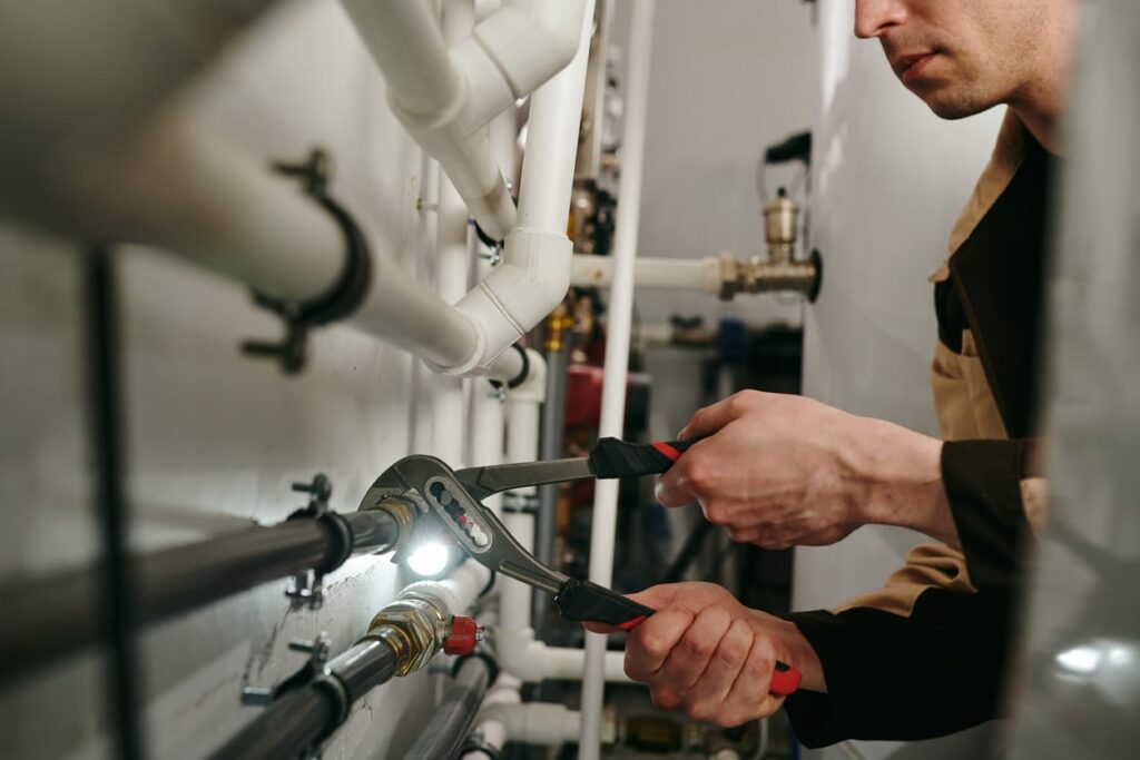 Plumbers maintaining commercial plumbing pipes in Holiday