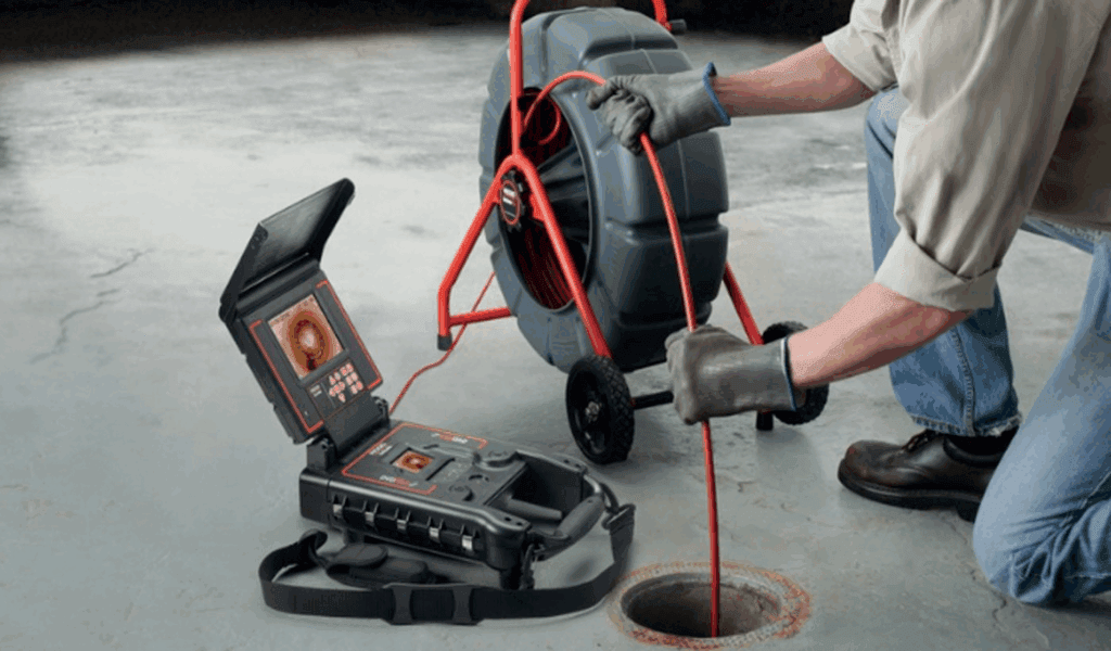 Technician performing a sewer camera inspection in Holiday